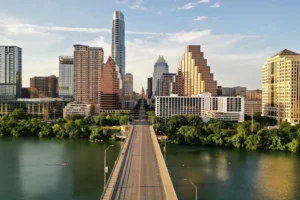 Austin skyline with Congress Avenue Bridge and Capitol in the distance.